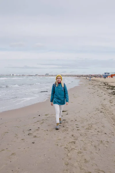 woman traveler walking along the beach