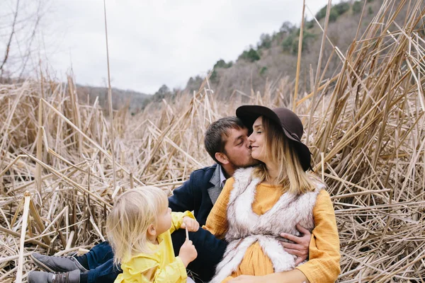 Young family among dry reeds — Stock Photo, Image