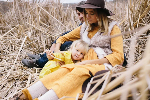 Young family among dry reeds Stock Photo
