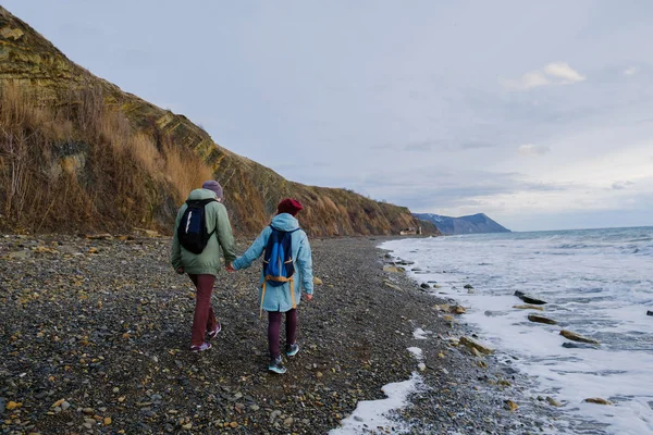 couple walking along shore