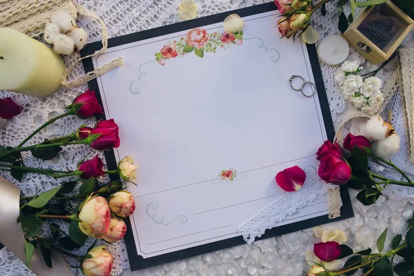 Wedding invitation, rings and roses