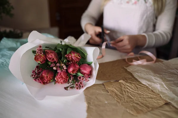 woman florist making bouquet