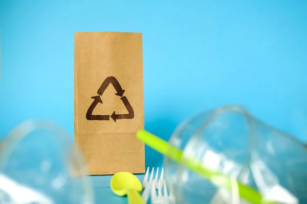 Craft paper bag with recycling sign and  Single use, Disposable tableware, Plastic pollution, waste. Plastic processing problem and ecological material, eco, ecology, recycle. Zero waste