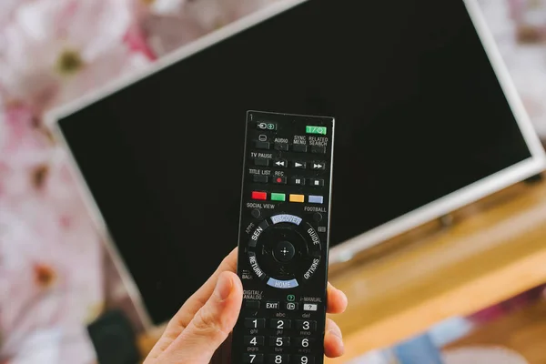 Hand holding a remote tv contro — Stock Photo, Image