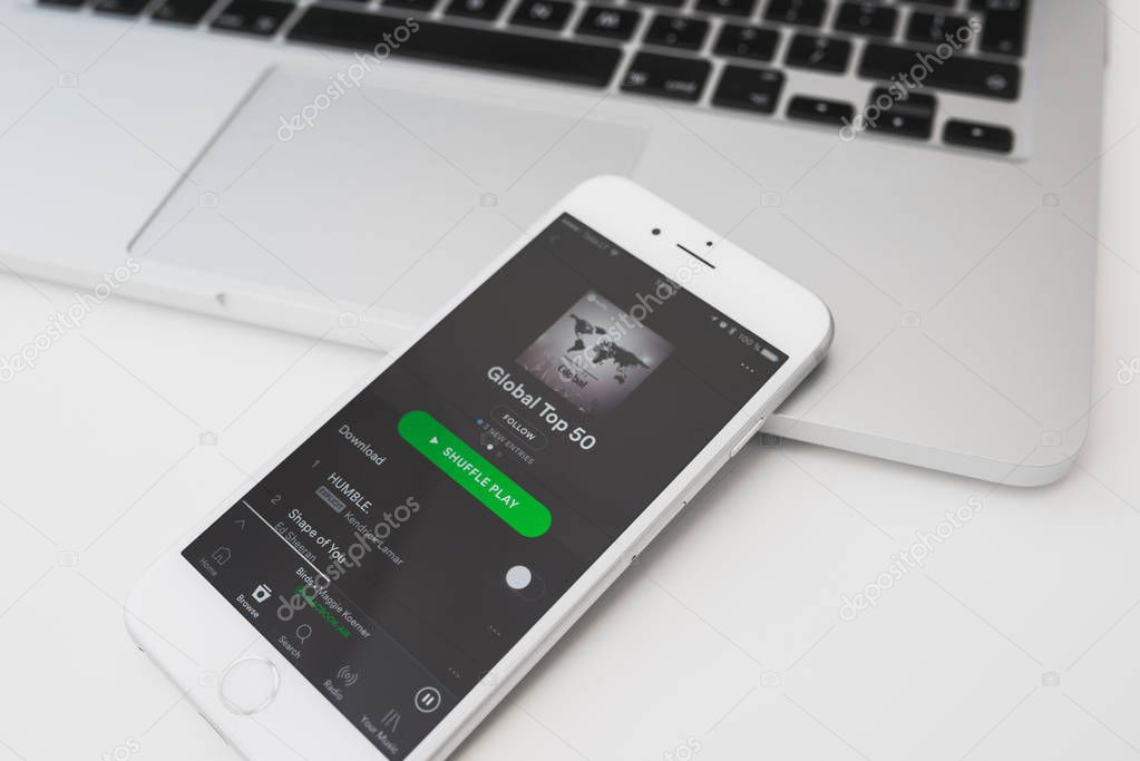 KAUNAS, LITHUANIA - APRIL 20, 2017: Control music at home with Sptify app on mobile. Spotify service developed by startup Spotify AB in Stockholm, Sweden