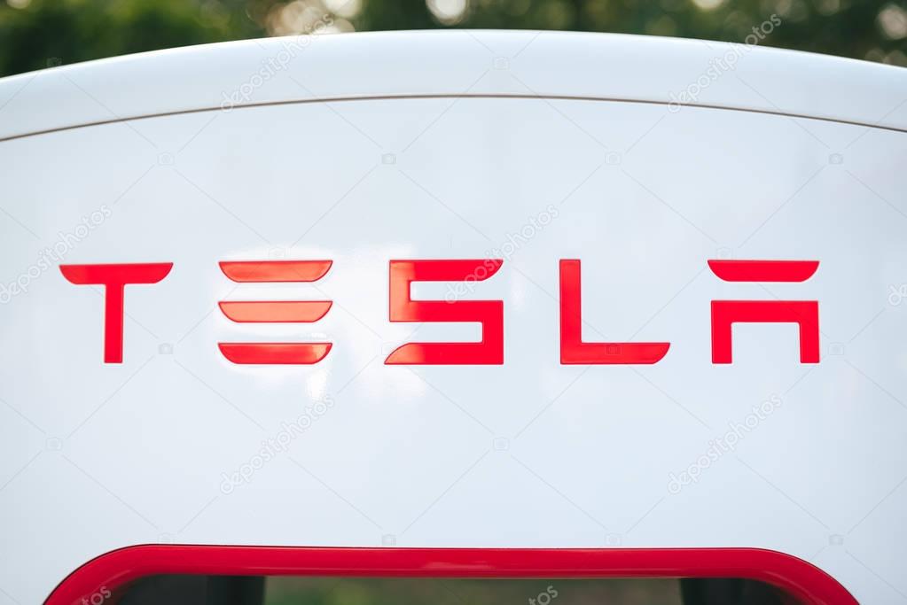 KATOWICE, POLAND - AUGUST 26, 2017: Tesla logo on Supercharger station. Tesla motors develops network of the charging stations across Europe and World