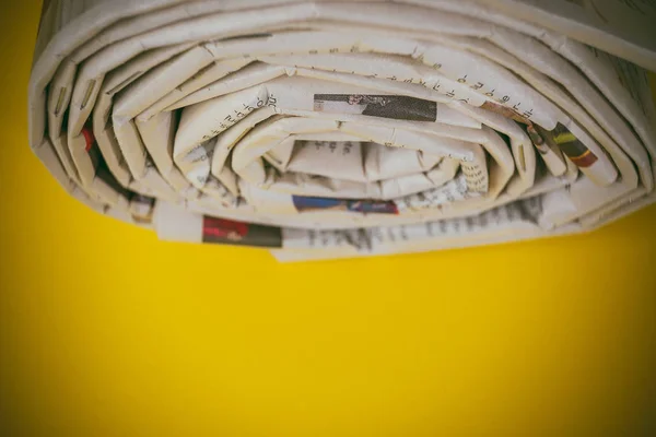 Closeup View Newspapers Roll Yellow Background — Stock Photo, Image