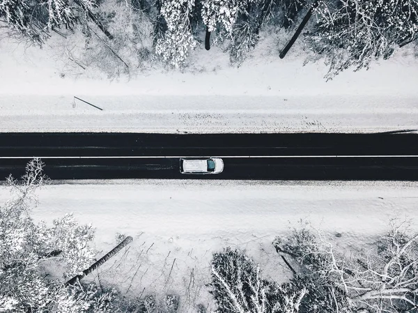 Drone aerial view of road in the snowy forest — Stock Photo, Image