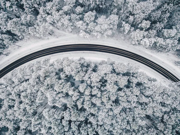 Drone vista aérea de la carretera en el bosque nevado — Foto de Stock