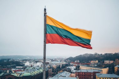 Lithuanian flag in the wind. Drone aerial view clipart