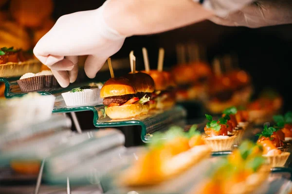 Small appetizers hamburgers and tarts — Stock Photo, Image