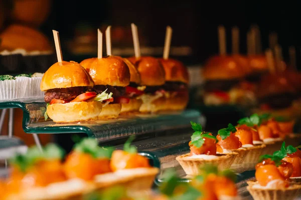 Small appetizers hamburgers and tarts — Stock Photo, Image