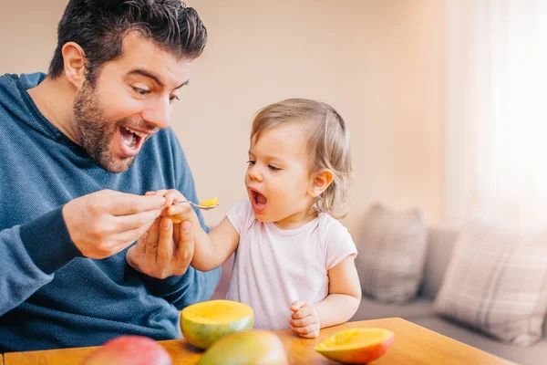 Close Young Happy Father Feeding Cute Little Girl Fresh Mango — Stock Photo, Image