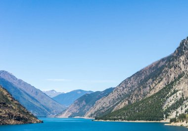 Seton göl kenarında mavi gökyüzü ile Lillooet British Columbia Kanada yüksek dağlar.