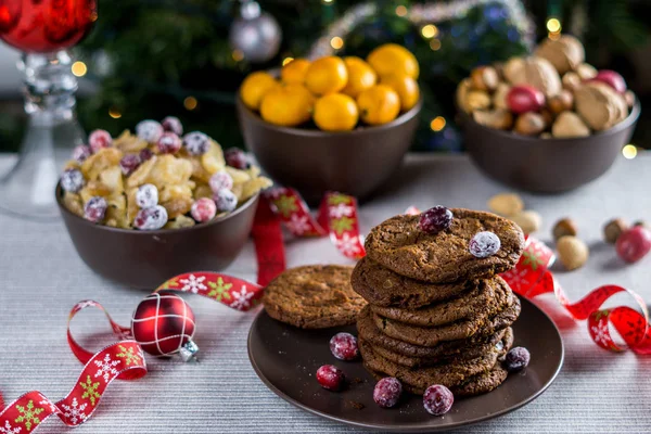 Freshly baked chocolate chip cookies on a table with blurred christmas tree background. — Stock Photo, Image