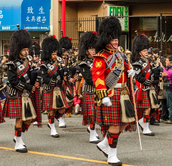 Vancouver, Canada - 2 februari 2014: Schotse kilt Pipe band maart in Chinees Nieuwjaar parade in Vancouver Canada. — Stockfoto