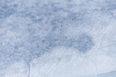 Eriyen buz arkaplanı veya doku mavi donmuş su