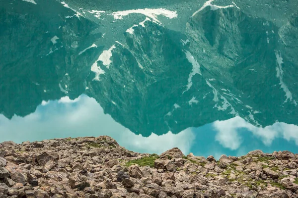 reflection of mountains in calm water of lake