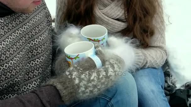 Guy and girl in the forest, drinking tea in winter — Stock Video