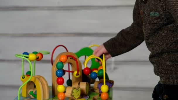 Cute little boy sitting on the floor and playing — Stock Video