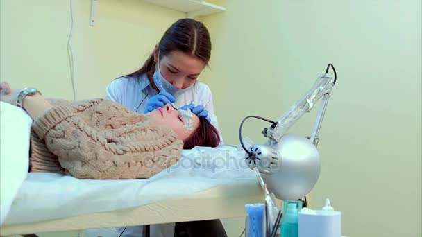 Esthéticienne faisant un maquillage permanent des cils . — Video