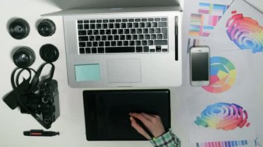 Yukarıdan görüntüleyin. Adam bir tasarım stüdyosu onun grafik tablet üzerinde çalışan bir fotoğrafçıdır.