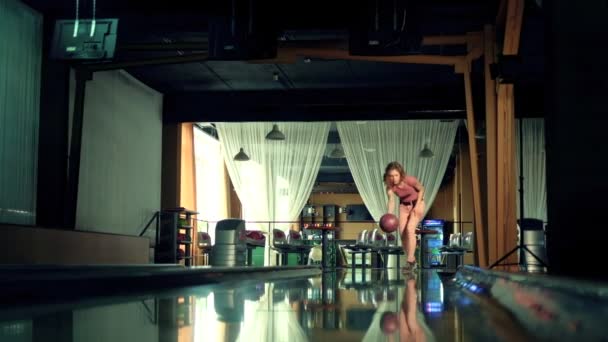 Jeune femme lance la balle dans un club de bowling Slow motion — Video