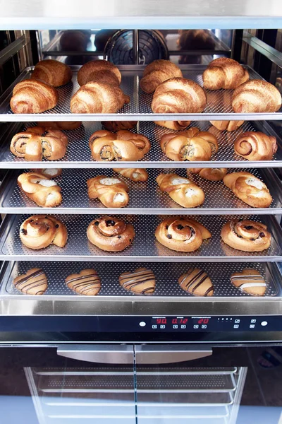 Dessert bread baking in Combi steamer. Production oven at the bakery. Baking bread. Manufacture of bread.