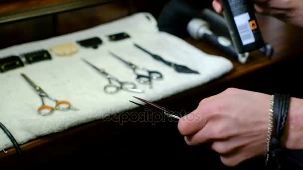 Barber takes scissors from a full tool board slow motion good — Stock Video