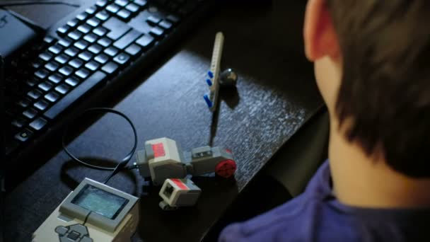 Joven profesor masculino ayudando a sus estudiantes a construir un robot 4k — Vídeos de Stock