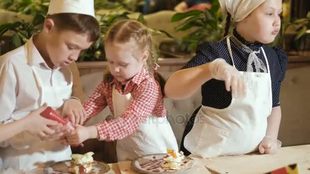 Gelukkige familie grappige jonge geitjes zijn de voorbereiding van het deeg, bak koekjes in de keuken 4k — Stockvideo