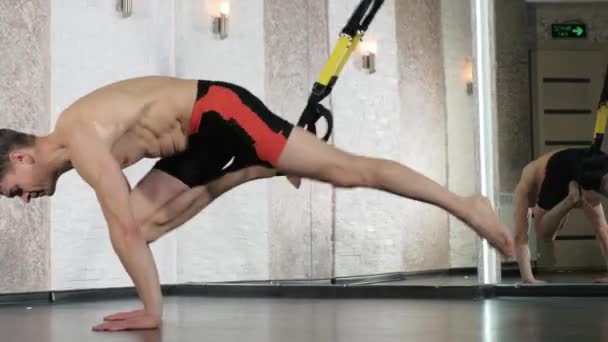 Man is engaged in trx exercises in the studio 4k — Stock Video