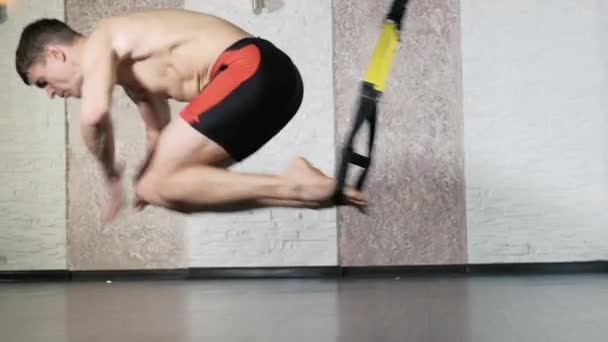 Man is engaged in trx exercises in the studio 4k — Stock Video