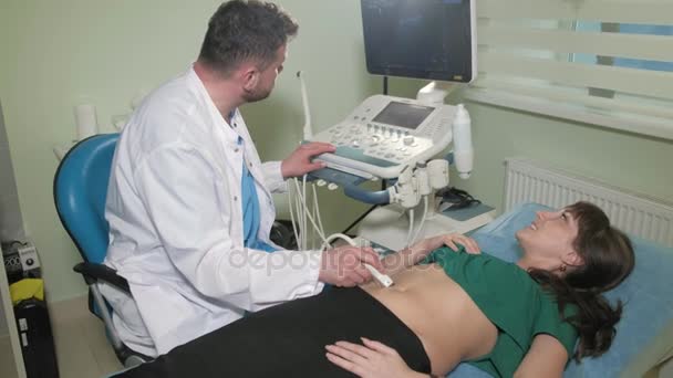 Médico haciendo ultrasonido 3d en el vientre de t mujer en la clínica 4k — Vídeo de stock