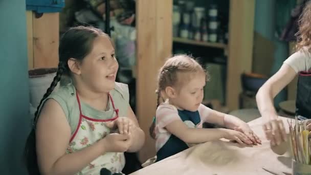 Clay potter hands wheel pottery work workshop teacher and girl pupil 4k — Stock Video