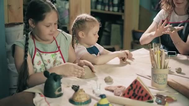 Clay potter hands wheel pottery work workshop teacher and girl pupil 4k — Stock Video