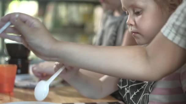 Close up portrait young baker examines and touching using finger chocolate 4k — Stock Video