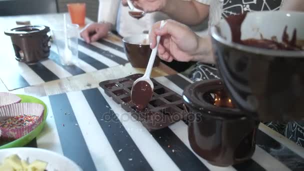 Primer plano retrato joven panadero examina y tocar con el dedo de chocolate 4k — Vídeo de stock