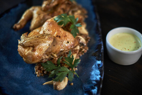 Grilled chicken Tabaka with sauce on stone plate. jpg