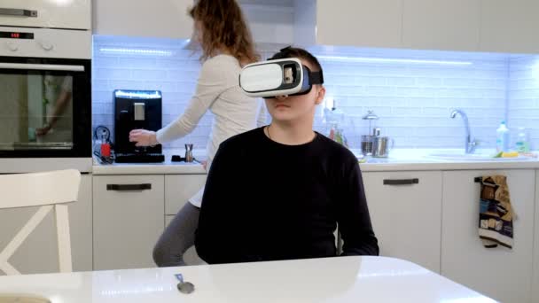 Homem vestindo fone de ouvido VR na cozinha. Usando gestos com as mãos . — Vídeo de Stock
