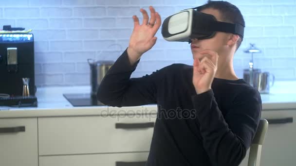 Man Wearing VR Headset at kitchen. Using Gestures with Hands. — Stock Video