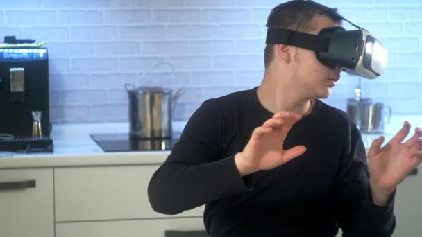 Man Wearing VR Headset at kitchen. Using Gestures with Hands. — Stock Video