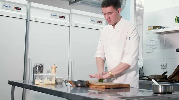 Chef cooks vegetables in a professional kitchen in a restaurant