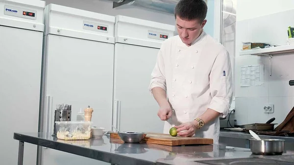 Chef cooks vegetables in a professional kitchen in a restaurant