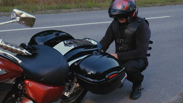 Mann fährt mit Motorrad eine Straße im Wald hinunter — Stockfoto