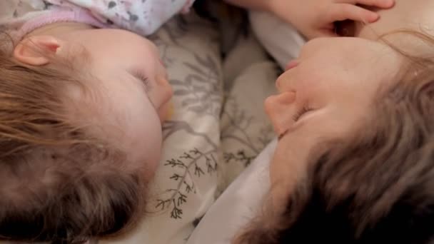 Happy woman and girls playing lying on the floor at home — Stock Video