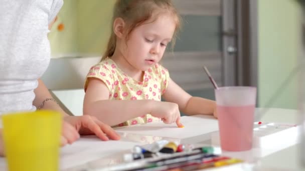 Família feliz mãe e criança pintura menina tintas em casa — Vídeo de Stock