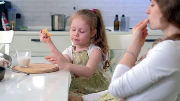 Mulher e menina bebendo leite na cozinha — Vídeo de Stock