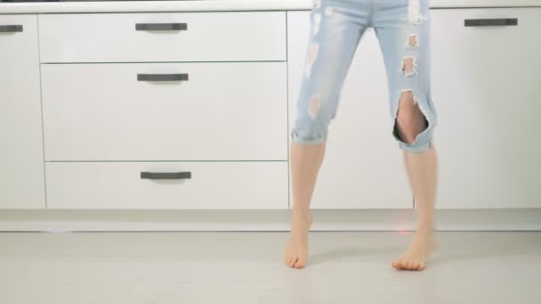 Веселая юная забавная женщина танцует дома на кухне — стоковое видео