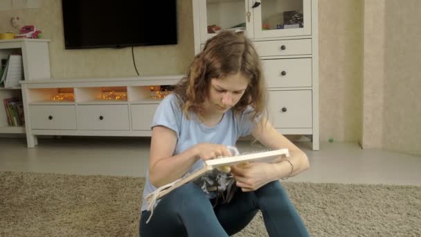 Een vrouw weeft op een weefgetouw een Pragtige borduurwerk gemaakt van garen, in een home studio, — Stockvideo